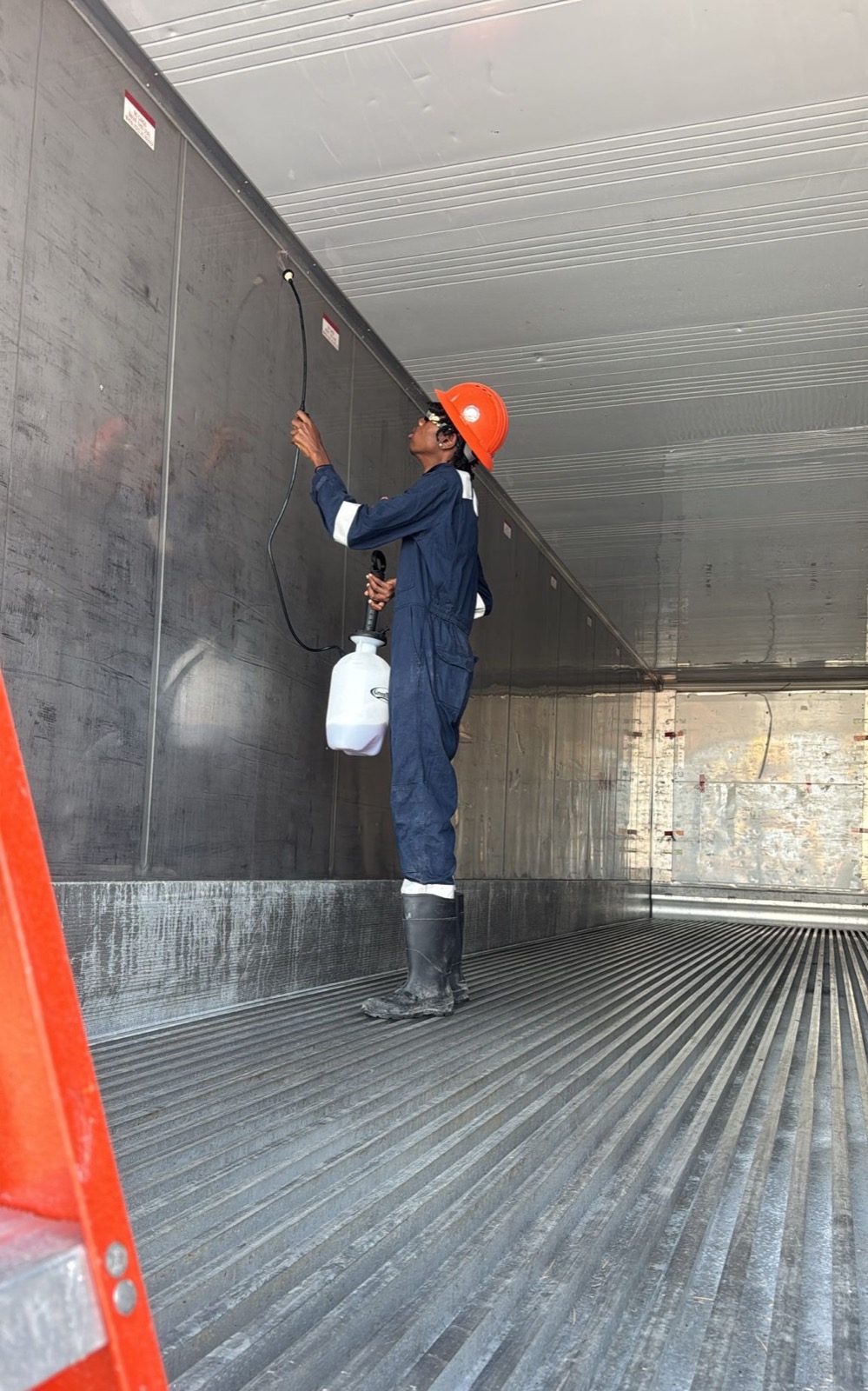 OEM technician treating the interior ceiling of a container