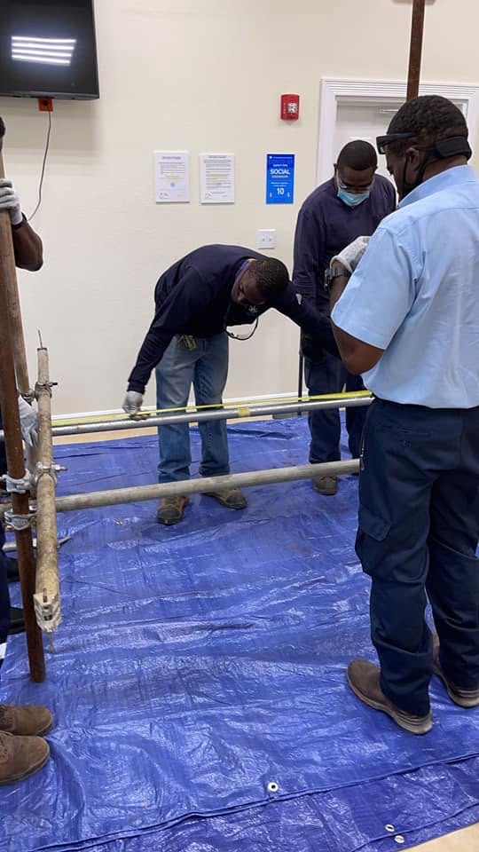 OEM Bahamas trainee assembling a scaffold tower during safety training