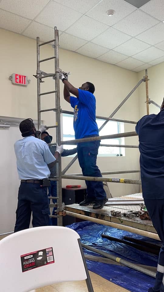 OEM Bahamas trainee leveling scaffold framing during safety training