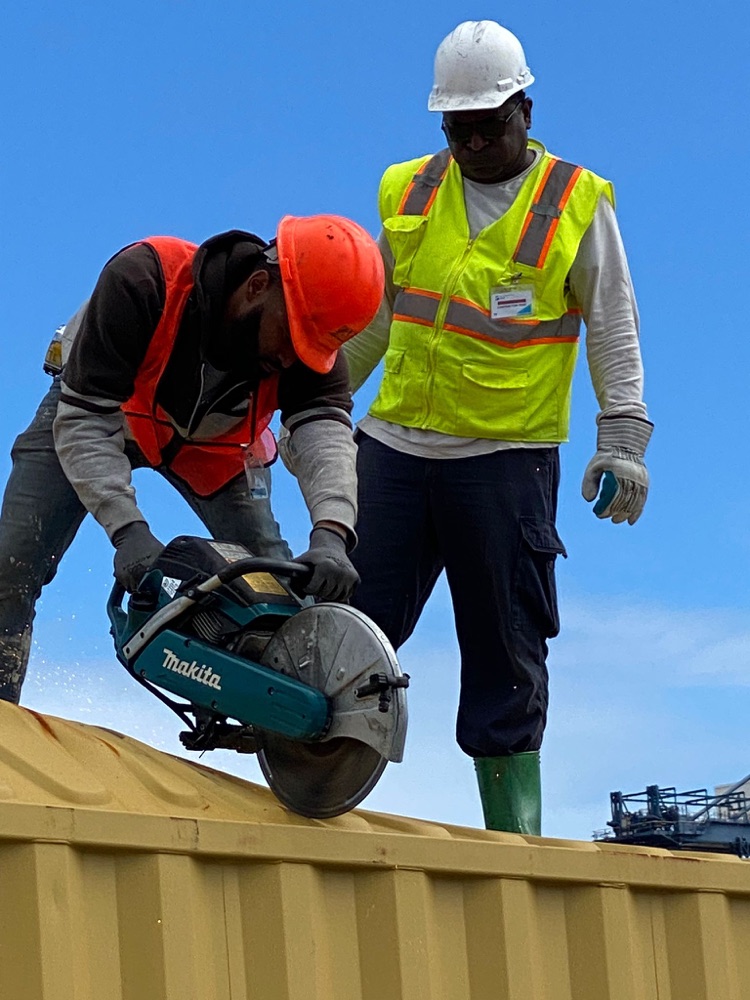 OEM Bahamas crew cutting into a container during a recovery job