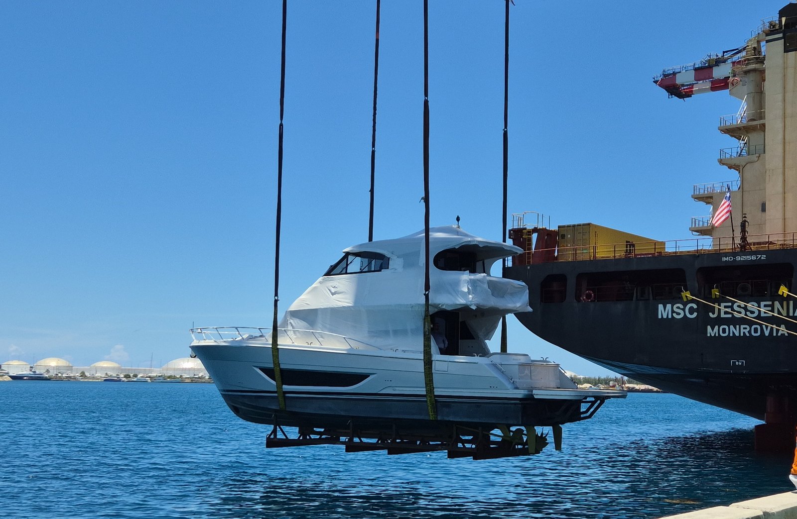 Yacht hoisted alongside the MSC Jessenia R at Freeport