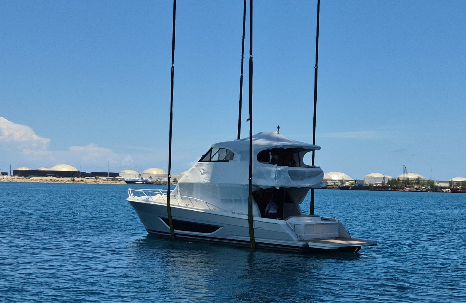 Yacht lowered toward its transport cradle
